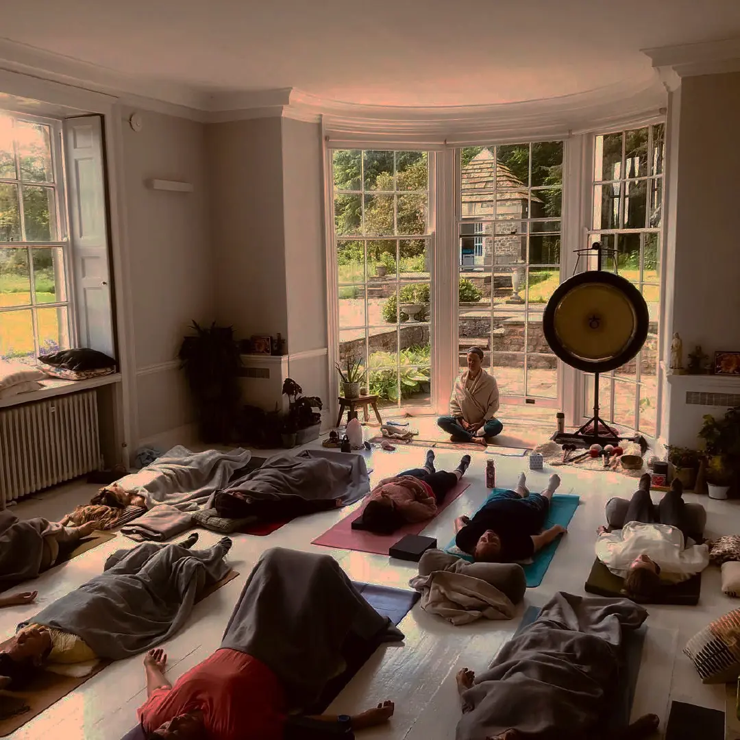 Rose leading an in-person yoga session