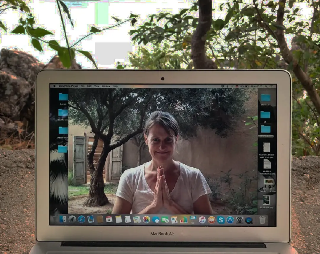 Online Groups - Photo of a laptop on the beach with a live Zoom class led by Rose Long.